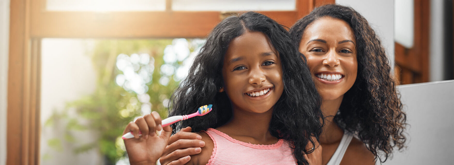 Cropped portrait of an attractive young woman and her daughter brushing their teeth in the bathroom at home.