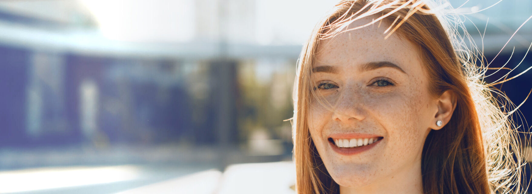 Close up portrait of a cute young woman with red hair and freckles